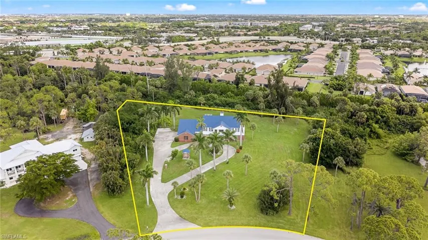 Aerial view of residential area featuring a nearby body of water and property boundaries highlighted