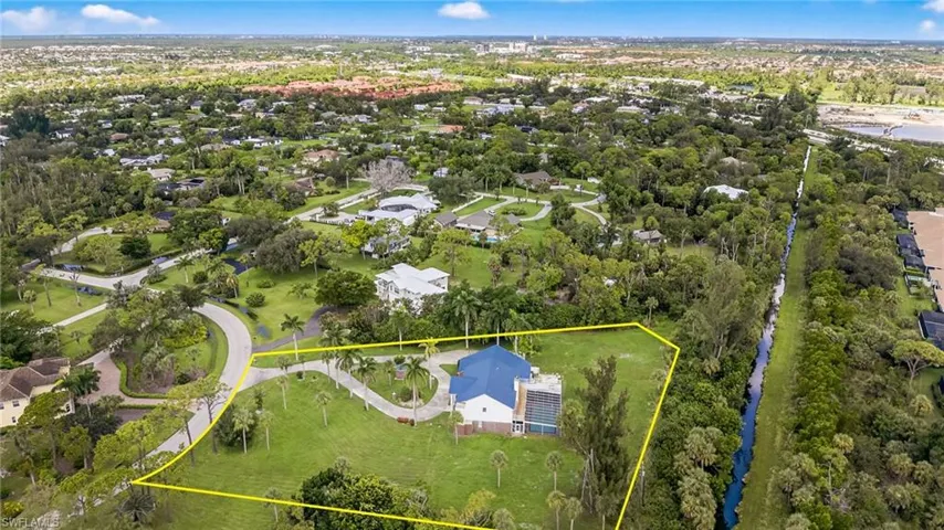 Aerial view of residential area featuring property boundaries highlighted