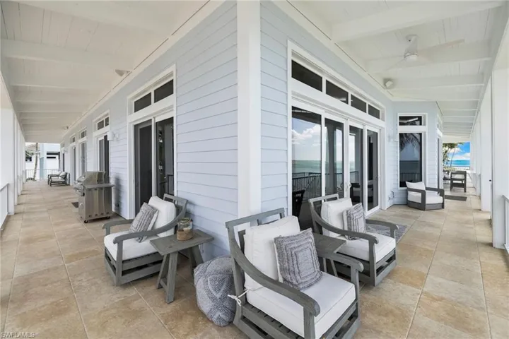 View of patio featuring grilling area, french doors, and a ceiling fan