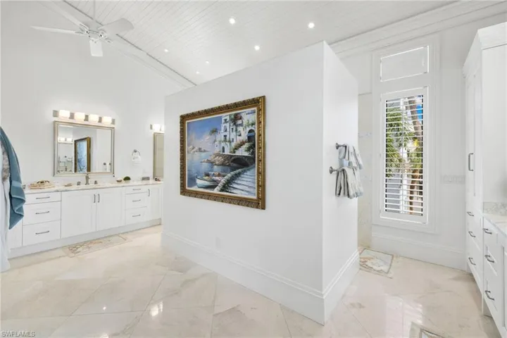 Bathroom featuring vanity, recessed lighting, ceiling fan, wooden ceiling, and a towering ceiling