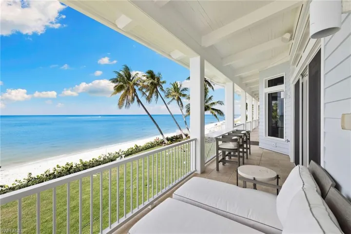 Balcony with view of water and beach