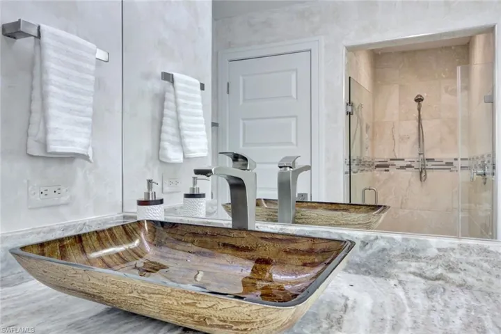 Bathroom featuring sink and a shower with door