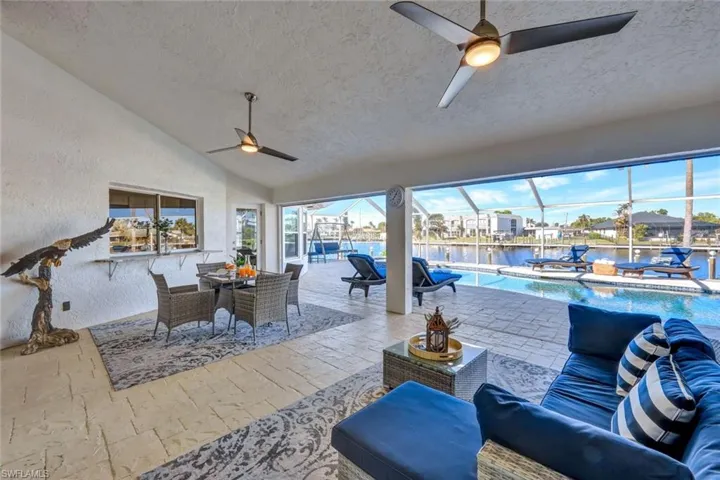 View of patio / terrace with outdoor lounge area, ceiling fan, a lanai, and a water view