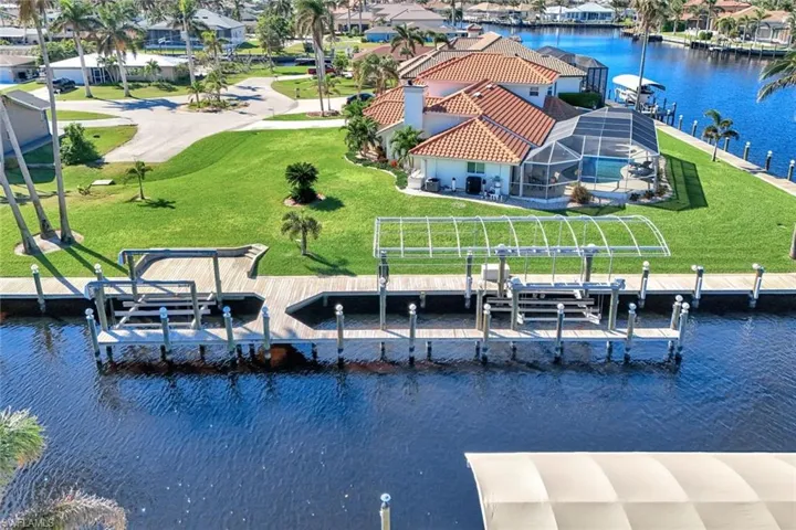 Birds eye view of property with a water view