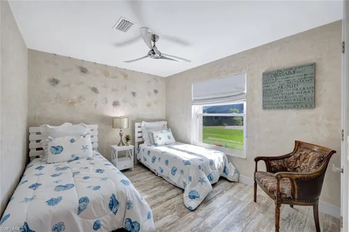 Bedroom with ceiling fan and light hardwood / wood-style flooring