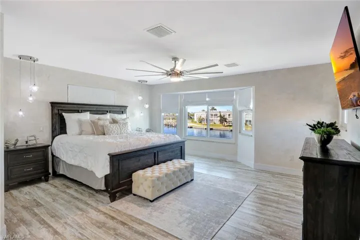 Bedroom featuring ceiling fan and light hardwood / wood-style floors