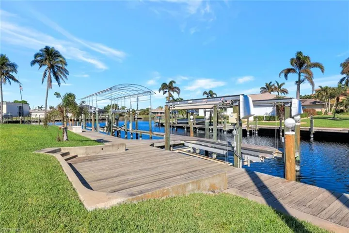 Dock area featuring a yard and a water view