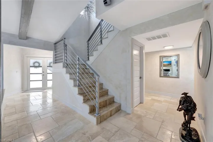 Stairs with beam ceiling and french doors
