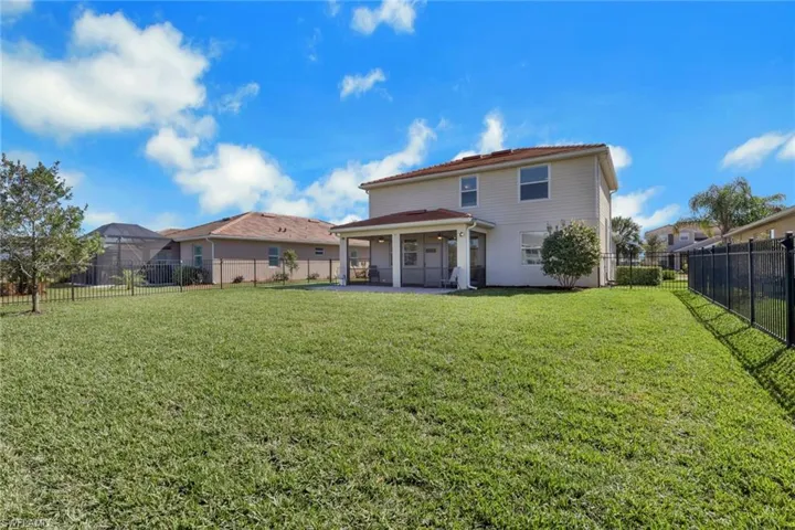 Back of property with a patio area and a fenced backyard