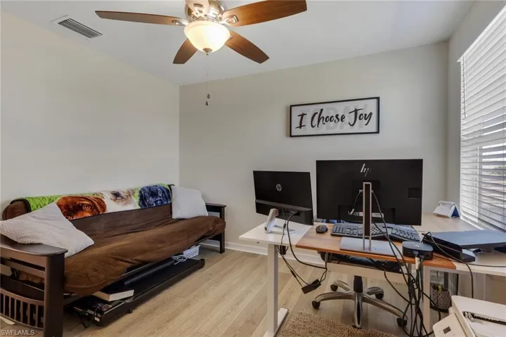 Office area featuring light wood-style flooring and a ceiling fan
