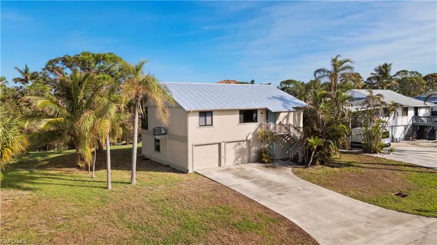 View of front of house featuring a garage and a front lawn