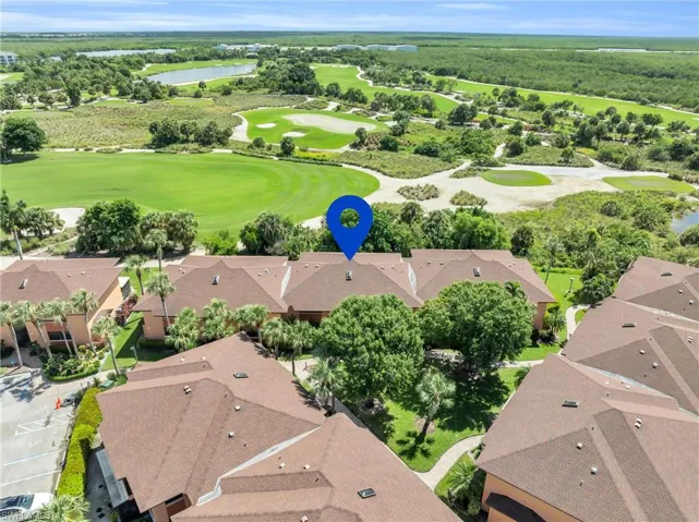 Drone / aerial view showing condo location featuring Hammock Bay Golf Course