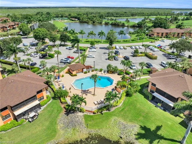 Drone / aerial view featuring community pool and golfer in cart