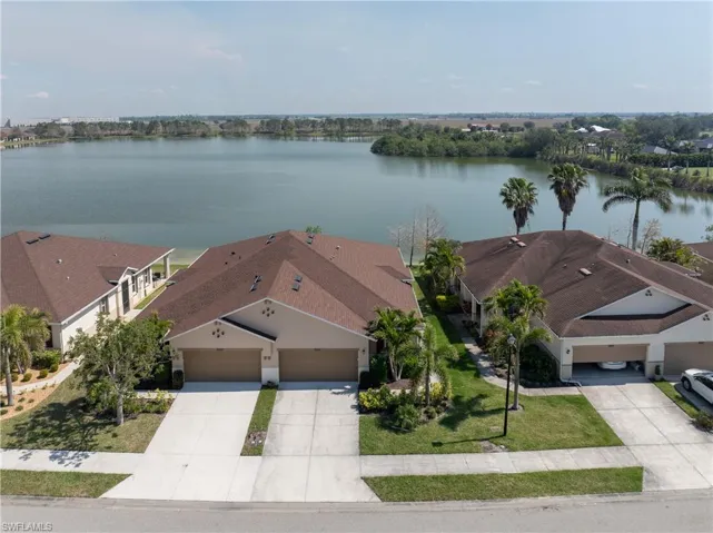 Birds eye view of property with a water view