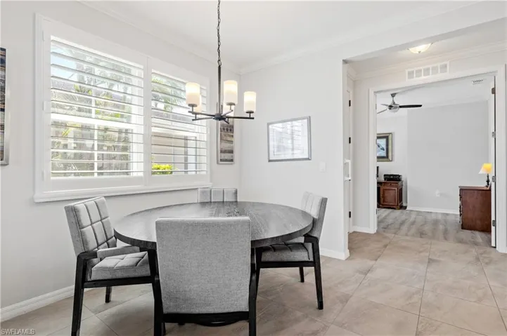 Dining room with plenty of natural light, baseboards, and ornamental molding