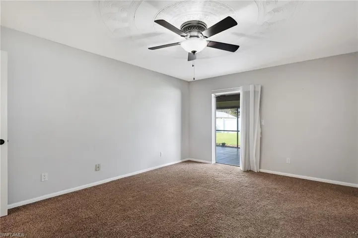 Primary bedroom - sliding door leading to patio.