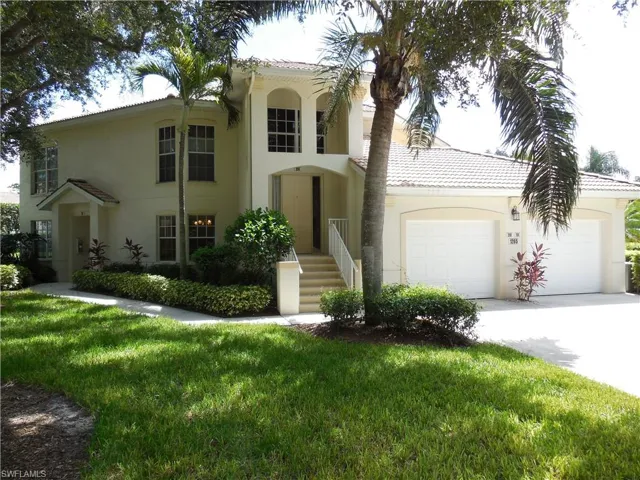 Mediterranean / spanish home with an attached garage, concrete driveway, a front yard, and stucco siding