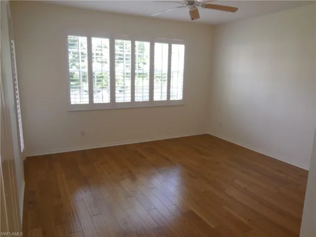 Spare room featuring hardwood / wood-style flooring and a ceiling fan