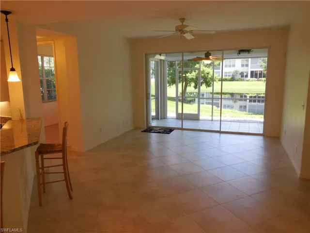 Unfurnished dining area with ceiling fan and light tile patterned floors