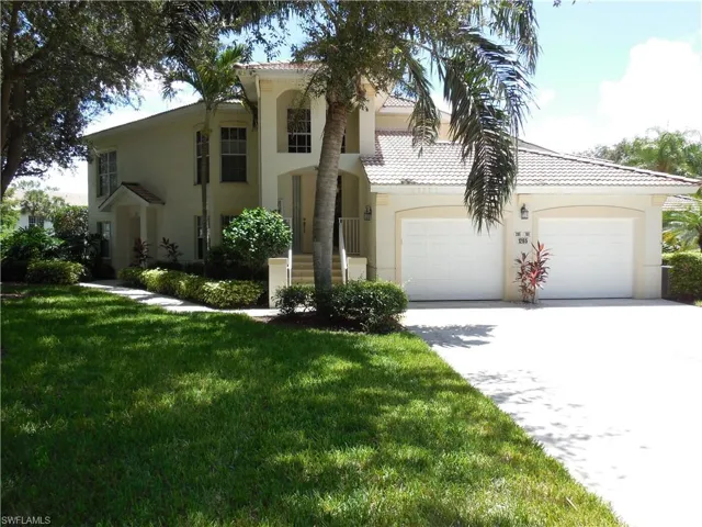 Mediterranean / spanish-style house with a tiled roof, concrete driveway, a front yard, and stucco siding