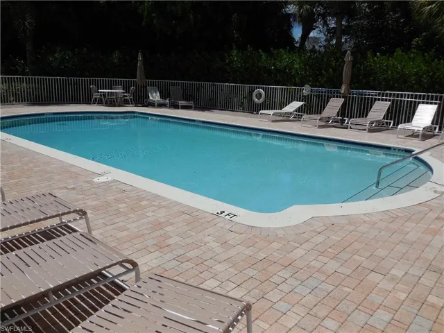 Community pool with a patio