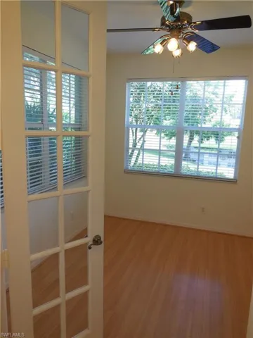 Empty room with wood finished floors and a ceiling fan