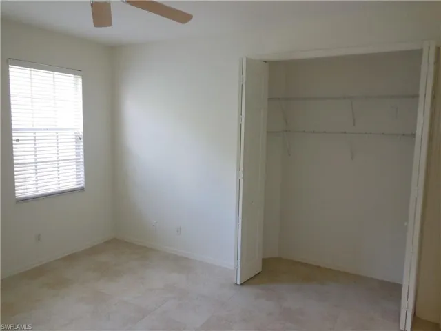 Unfurnished bedroom featuring a closet and a ceiling fan