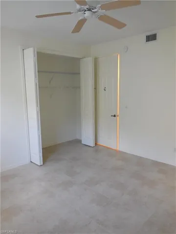 Unfurnished bedroom with a ceiling fan and a closet