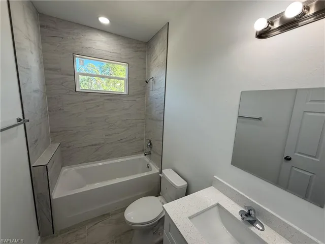 Full bath featuring vanity and shower / washtub combination