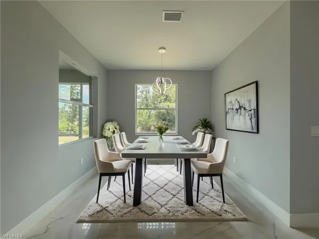 Dining room featuring an inviting chandelier, baseboards, and visible vents
