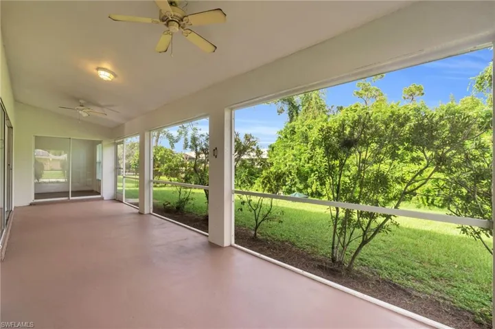 Unfurnished sunroom with lofted ceiling and ceiling fan