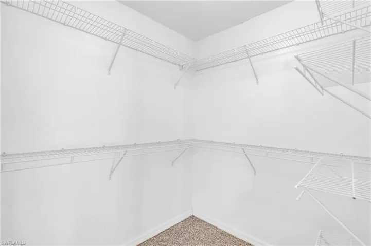 Spacious closet with carpet floors