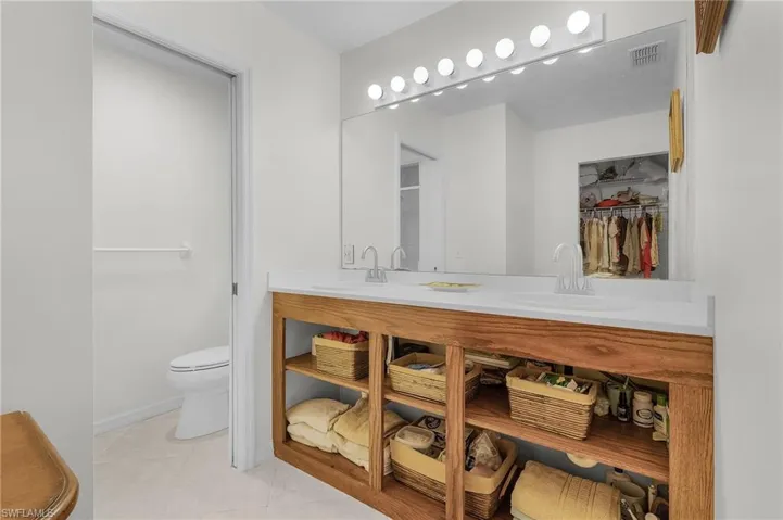 Bathroom featuring tile patterned floors, vanity, and toilet