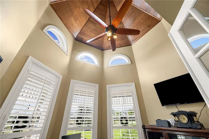 Detailed view of a ceiling fan and wooden ceiling