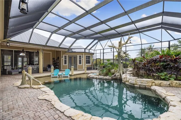 Outdoor pool with a sunroom, a lanai, french doors, and a patio area