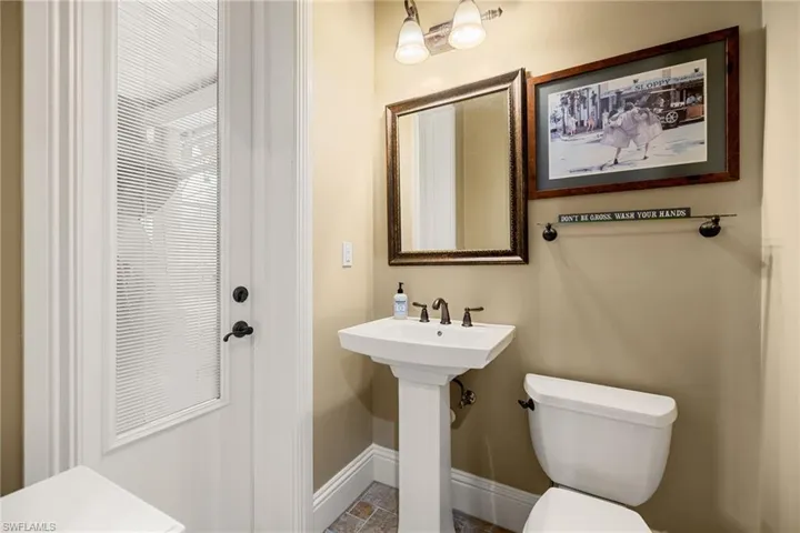 Bathroom with toilet and baseboards