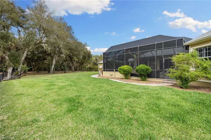 View of yard with glass enclosure and a sunroom