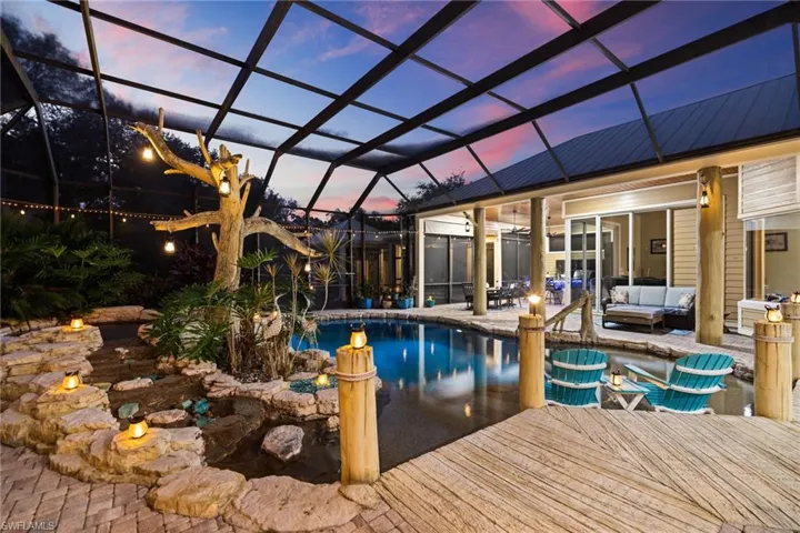 Outdoor pool with glass enclosure, a sunroom, an outdoor hangout area, and a patio