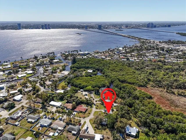 Aerial perspective of suburban area with a notable bridge and a nearby body of water