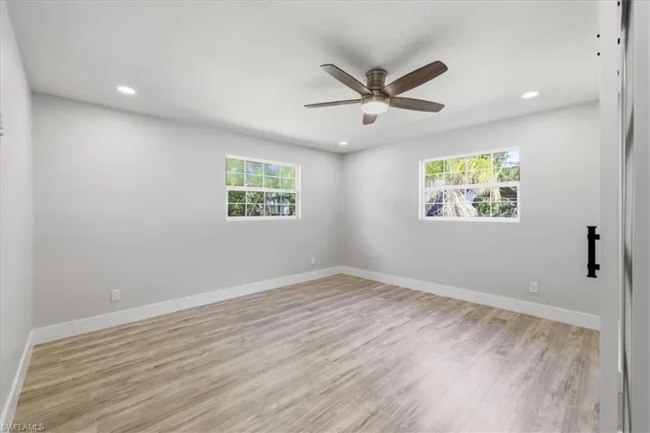 Spare room with light wood-style flooring, recessed lighting, a ceiling fan, and healthy amount of natural light