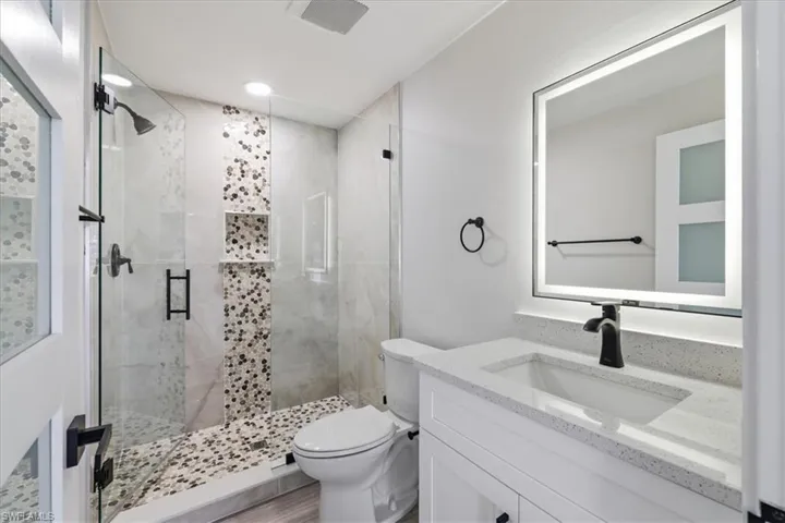Full bath 2 with a stall shower and vanity