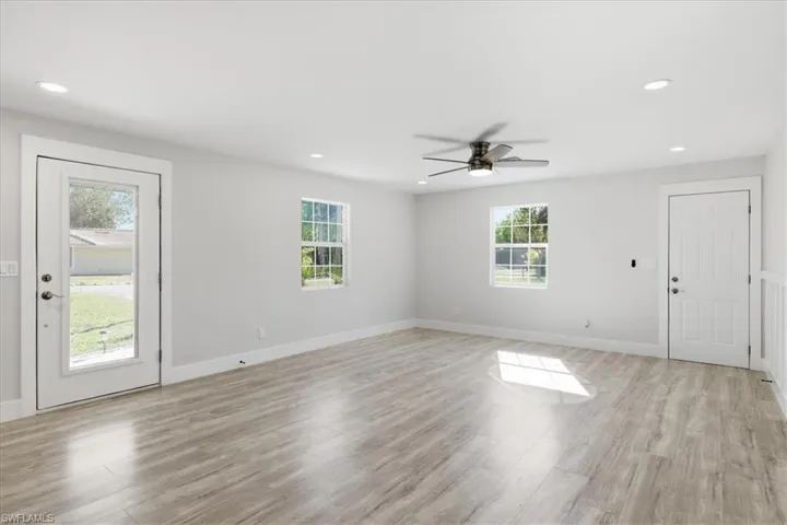 Foyer entrance with a ceiling fan, recessed lighting, and light wood-type flooring