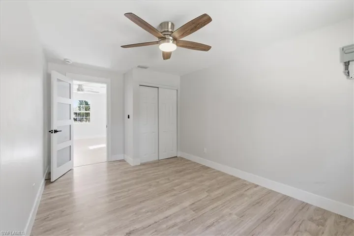 Unfurnished bedroom 3 featuring a closet, light wood-type flooring, and ceiling fan
