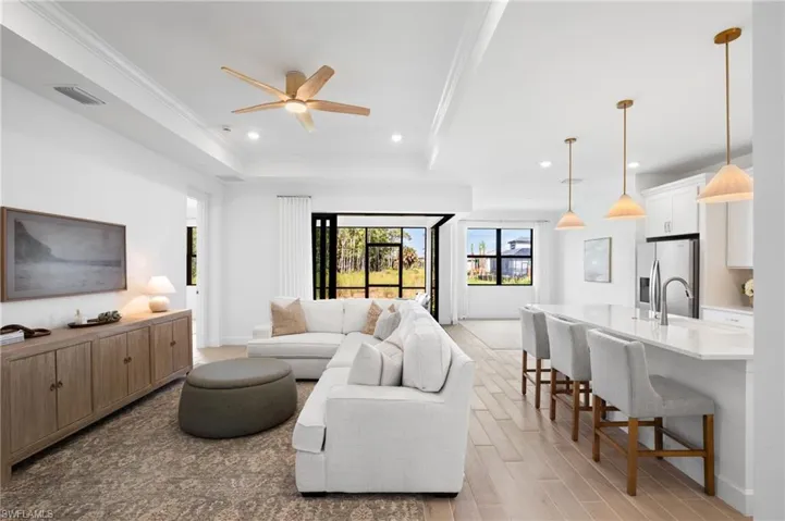 Recessed lighting, tile flooring, and a ceiling fan enhance the living area