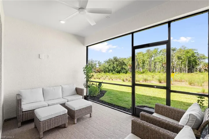 Screened lanai with a ceiling fan, recessed lighting, and textured walls