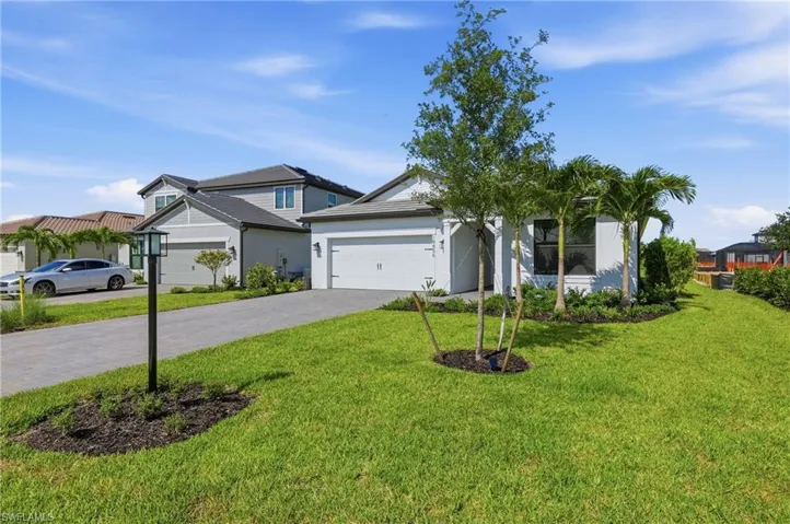 Contemporary exterior with a white facade, a dark gray roof, and an attached two-car garage