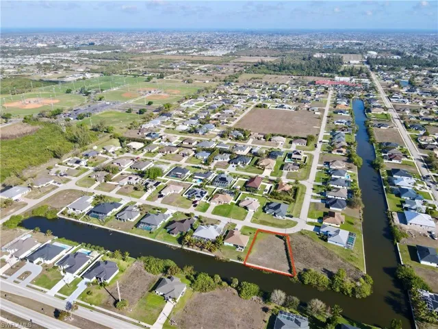 View of property location with nearby suburban area and a nearby body of water