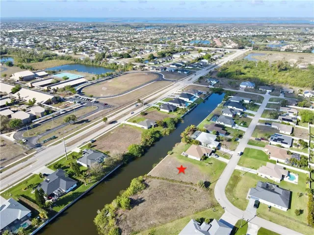 Aerial overview of property's location with a large body of water and nearby suburban area