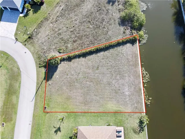 Aerial view of property's location featuring a large body of water and property parcel outlined