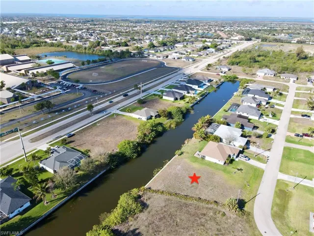 Aerial view of property's location featuring nearby suburban area